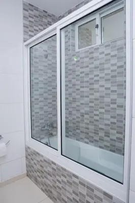 a bathroom with a large window in a room at Nice And Modern with king size bed in Praia