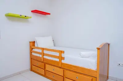 a bedroom with a bed with a wooden dresser at Nice And Modern with king size bed in Praia
