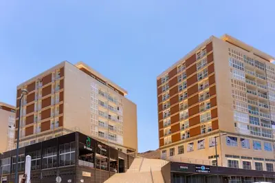 two tall buildings next to each other on a street at Bliss Apartments - T2 Nicole in Mindelo
