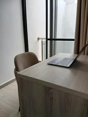 a laptop computer sitting on top of a wooden table at Charming House Tarrafal in Tarrafal