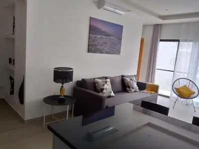 a living room with a couch and a table at Charming House Tarrafal in Tarrafal
