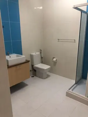 a bathroom with a toilet and a sink and a shower at Apartamento Oiá Mindelo in Mindelo
