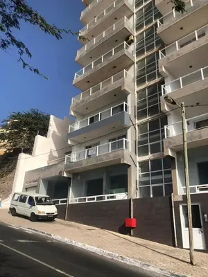 a white van parked in front of a building at Apartamento Oiá Mindelo in Mindelo