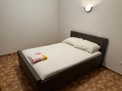 a bed with two pillows on it in a room at Apartment T3 for rent in Porto Novo in Porto Novo