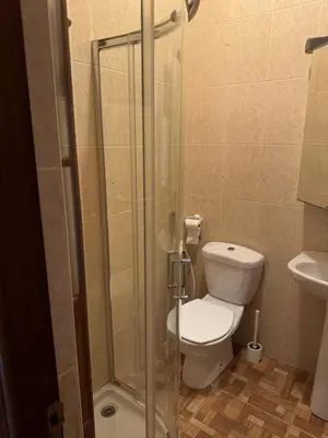 a bathroom with a toilet and a glass shower at Apartment T3 for rent in Porto Novo in Porto Novo