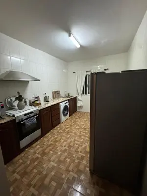 a kitchen with a refrigerator in the middle of it at Apartment T3 for rent in Porto Novo in Porto Novo