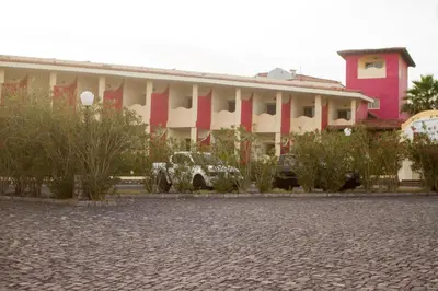 a building with a car parked in front of it at Hotel Santantao Art Resort in Porto Novo