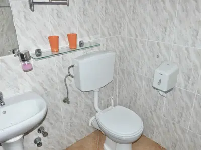 a bathroom with a white toilet and a sink at Hotel MiraBela in Santa Maria