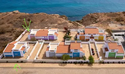 an overhead view of a group of houses next to the ocean at Serra's Village in Vila do Maio