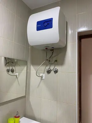 a bathroom with a shower with a camera on the wall at Katila-Rooms-Lima in Espargos
