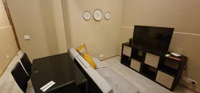 a living room with a couch and a flat screen tv at City Center Mindelo 37 in Mindelo