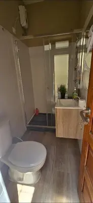 a bathroom with a toilet and a sink and a shower at City Center Mindelo 37 in Mindelo