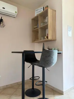 a black desk with a chair in a room at Tropical Issara Sal in Santa Maria