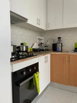 a kitchen with a stove with pots and pans on it at Casa do Encanto in Praia