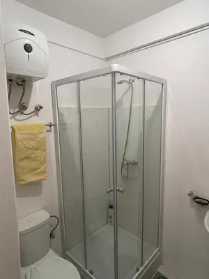 a shower stall in a bathroom with a toilet at Casa do Encanto in Praia