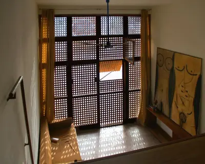 a room with a door open to a room with a chair at Paz Apartment in Mindelo