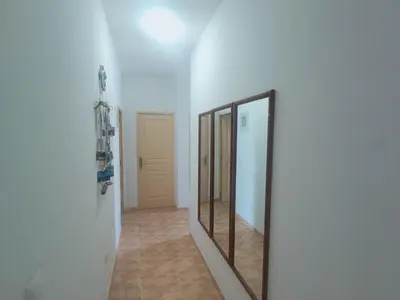 a hallway with two mirrors on a white wall at 1 chambre proche aeroporto cabo verde in Espargos