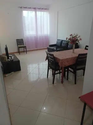 a living room with a table and chairs and a couch at Gamboa Djeu in Praia