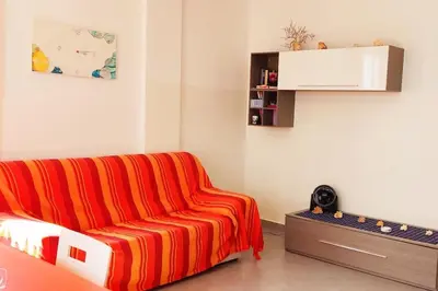 a living room with a orange couch in a room at Modern apartment in the Center in Sal Rei