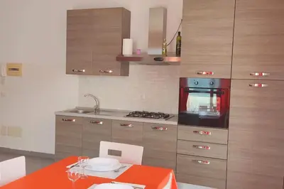 a kitchen with an orange table and a stove at Modern apartment in the Center in Sal Rei
