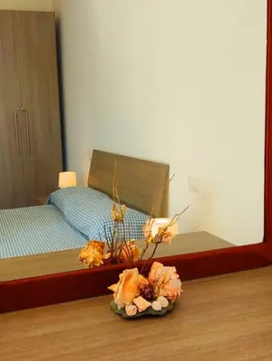 a bedroom with a bed and a vase of flowers at Modern apartment in the Center in Sal Rei