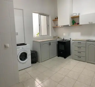 a kitchen with a washing machine and a washer at Flat Mindelo 30 in Mindelo