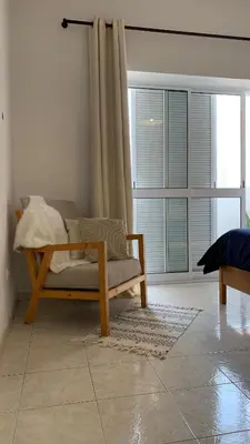 a living room with a couch and a large window at Flat Mindelo 30 in Mindelo