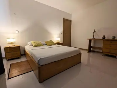 a bedroom with a large bed and two night stands at Vila Prainha in Praia