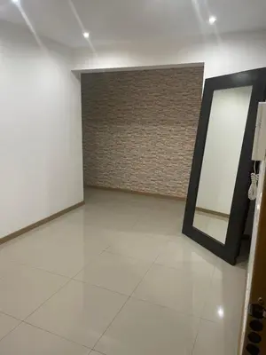 a white room with a mirror and a wall at Meraki's Apartment in Praia