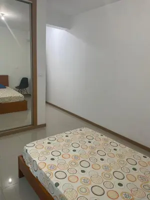 a bedroom with a bed and a large mirror at Meraki's Apartment in Praia