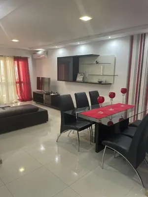 a living room with a table with wine glasses on it at Meraki's Apartment in Praia