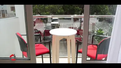 a table and two chairs on a balcony with a table and chairs at Guest House Lina Elisa in Mindelo