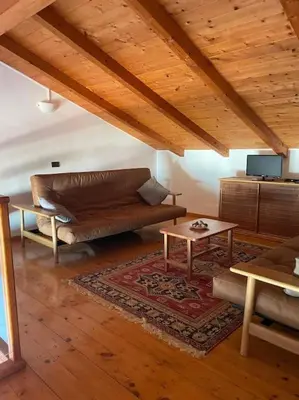 a living room with a couch and a table at Oceanfront Apt 25 Porto Antigo II in Santa Maria
