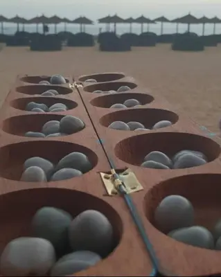 a row of brown baskets filled with eggs on a beach at Oceanfront Apt 25 Porto Antigo II in Santa Maria