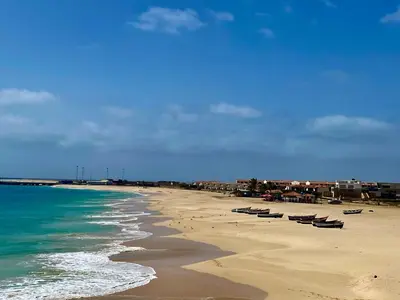 a beach with boats on the sand and the ocean at Estudio para dos personas-Stella Maris Villa FREE PICK UP in Calheta Do Maio