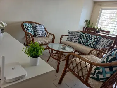 a living room with a couch and chairs and a table at Brisa e Paz in Praia