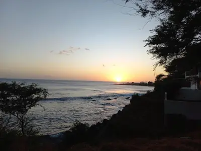 a sunset over the ocean with the sun setting at Brisa e Paz in Praia