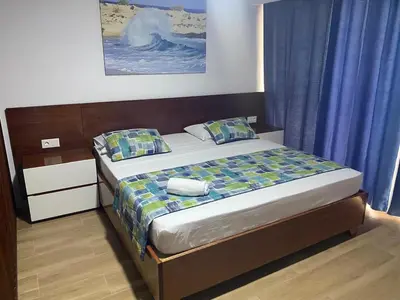 a bed in a bedroom with blue curtains and a bed sidx sidx sidx at Mota Residência in Santa Maria