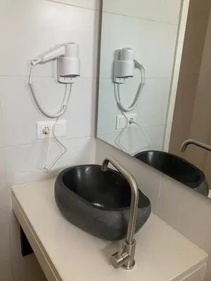 a bathroom with a black sink and a mirror at Mota Residência in Santa Maria