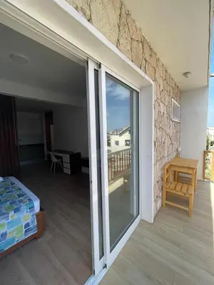 a bedroom with a sliding glass door to a balcony at Mota Residência in Santa Maria