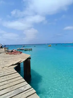 a dock in the ocean with boats in the water at Apartamento Paradise in Santa Maria