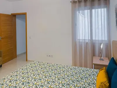a bedroom with a large bed and a window at Apartamento Paradise in Santa Maria