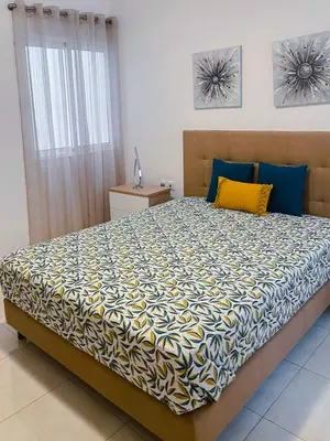 a bedroom with a large bed with blue and yellow sheets at Apartamento Paradise in Santa Maria