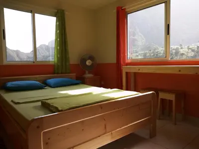 a bedroom with a bed and two windows at SANDRO Paul Residenciel in Paul