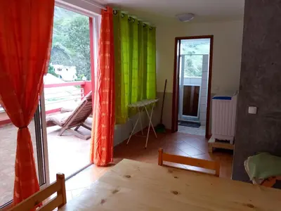 a room with green and red curtains and a table at SANDRO Paul Residenciel in Paul
