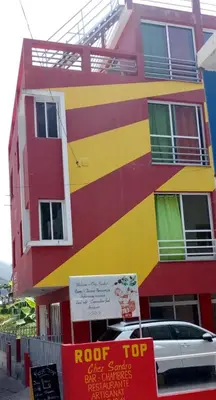 a colorful building with a car parked in front of it at SANDRO Paul Residenciel in Paul