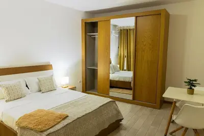 a bedroom with a large bed and a mirror at Jet Ap & Car 12 - AC in Praia