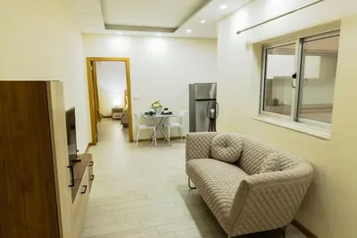 a living room with a chair and a table at Jet Ap & Car 12 - AC in Praia