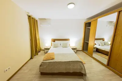 a bedroom with two beds and a large mirror at Jet Ap & Car 12 - AC in Praia