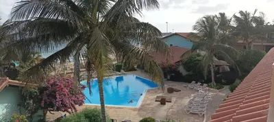 an overhead view of a swimming pool with palm trees at Appartamento t0 n 7 situato complesso turistico porto antico 2 in Santa Maria